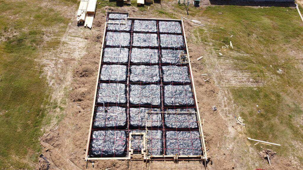 Pre-pour metal shop slab with reinforced grade beams and foundation preparation near Houston, Texas