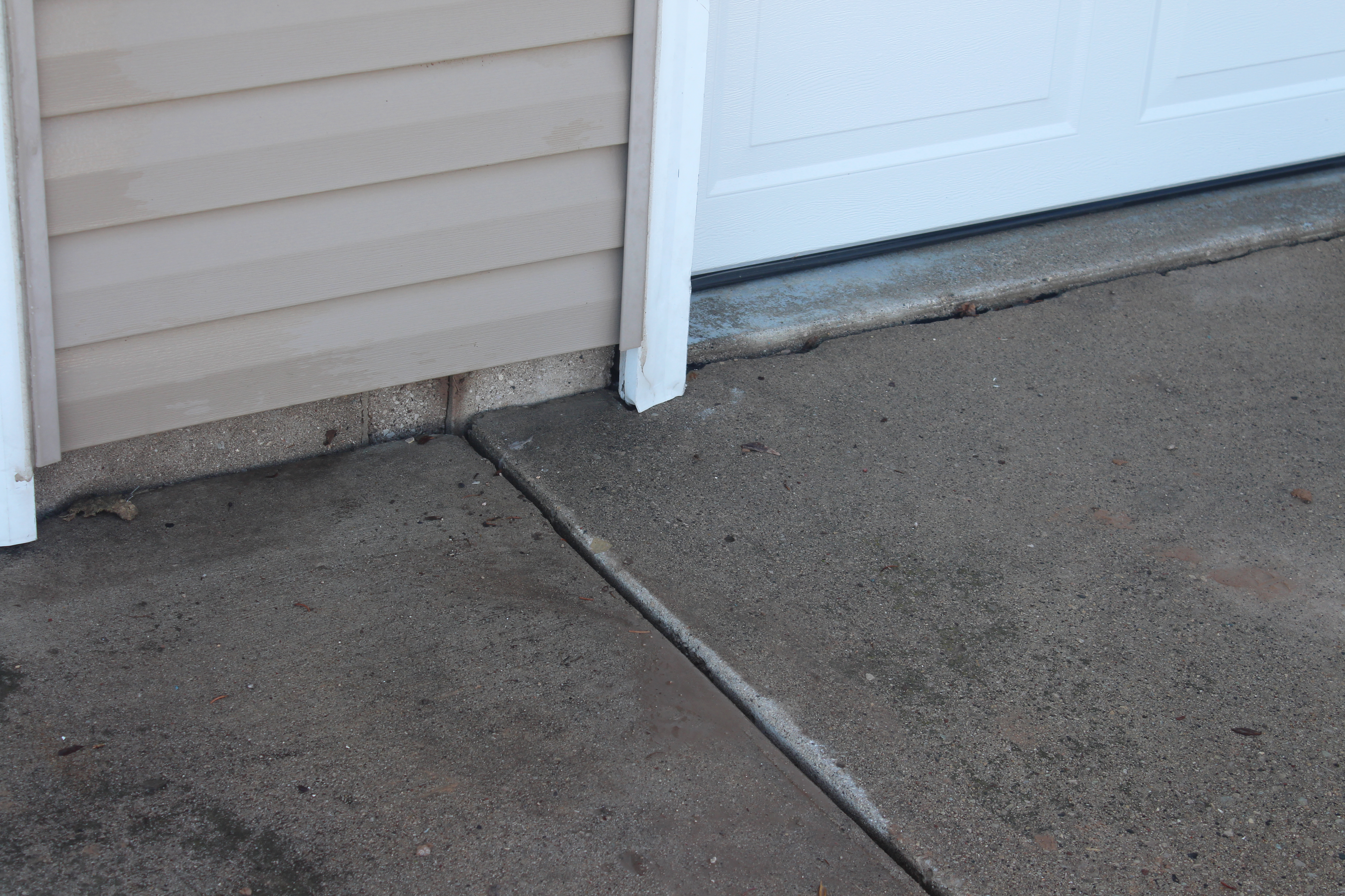 lifted and stabilized concrete pad after polyurethane foam injection Houston TX