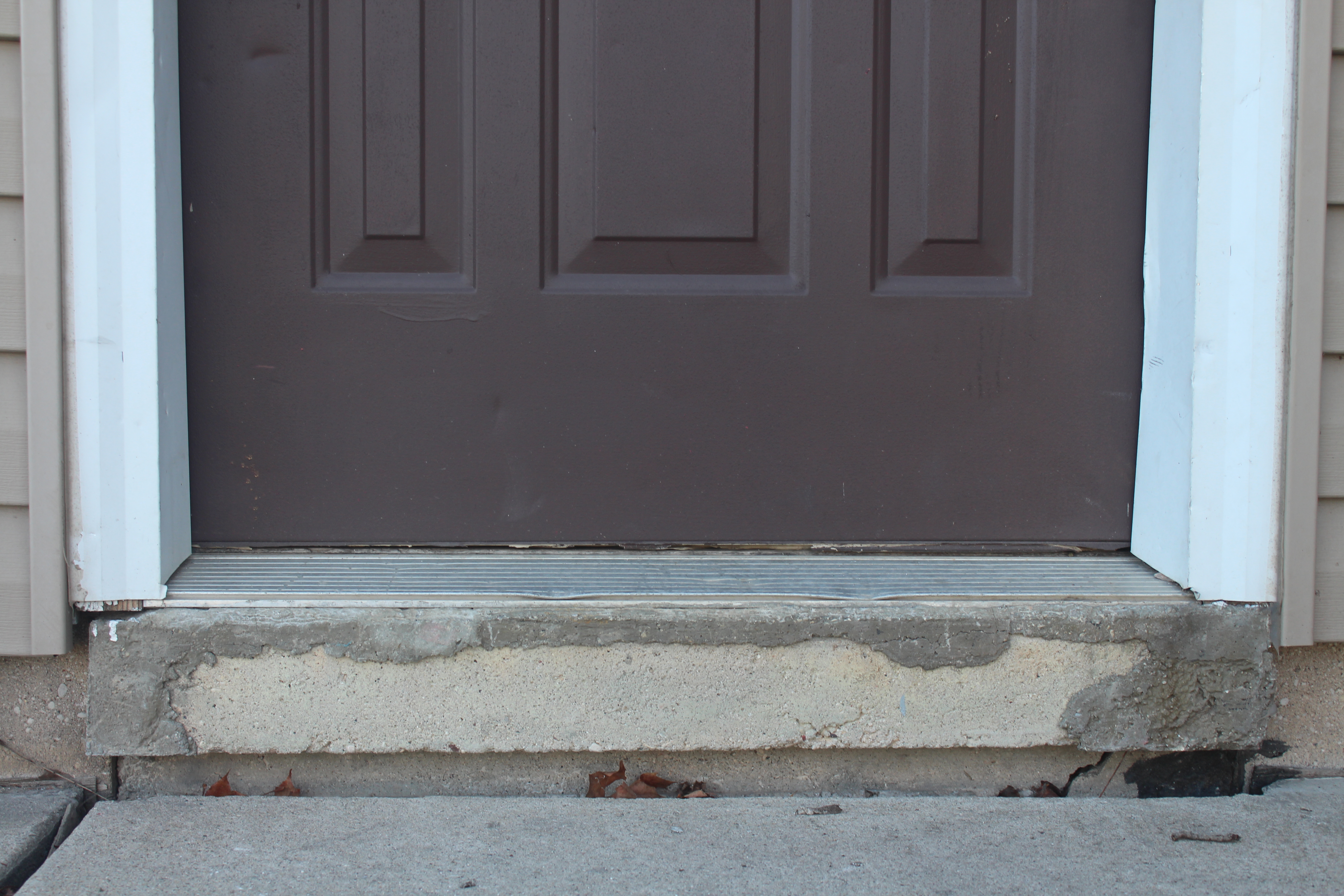 sunken uneven concrete entry steps before leveling repair Houston TX