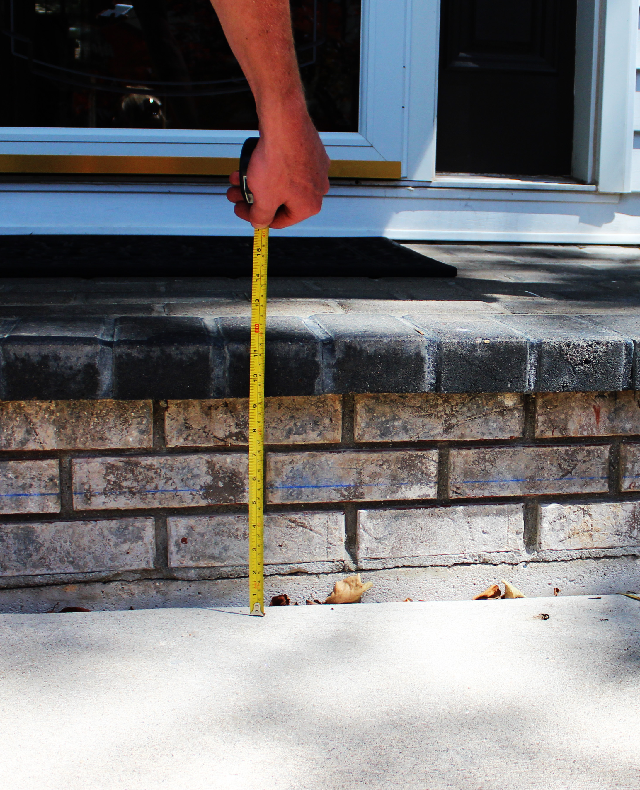 sunken cracked concrete front porch slab before leveling repair Houston TX