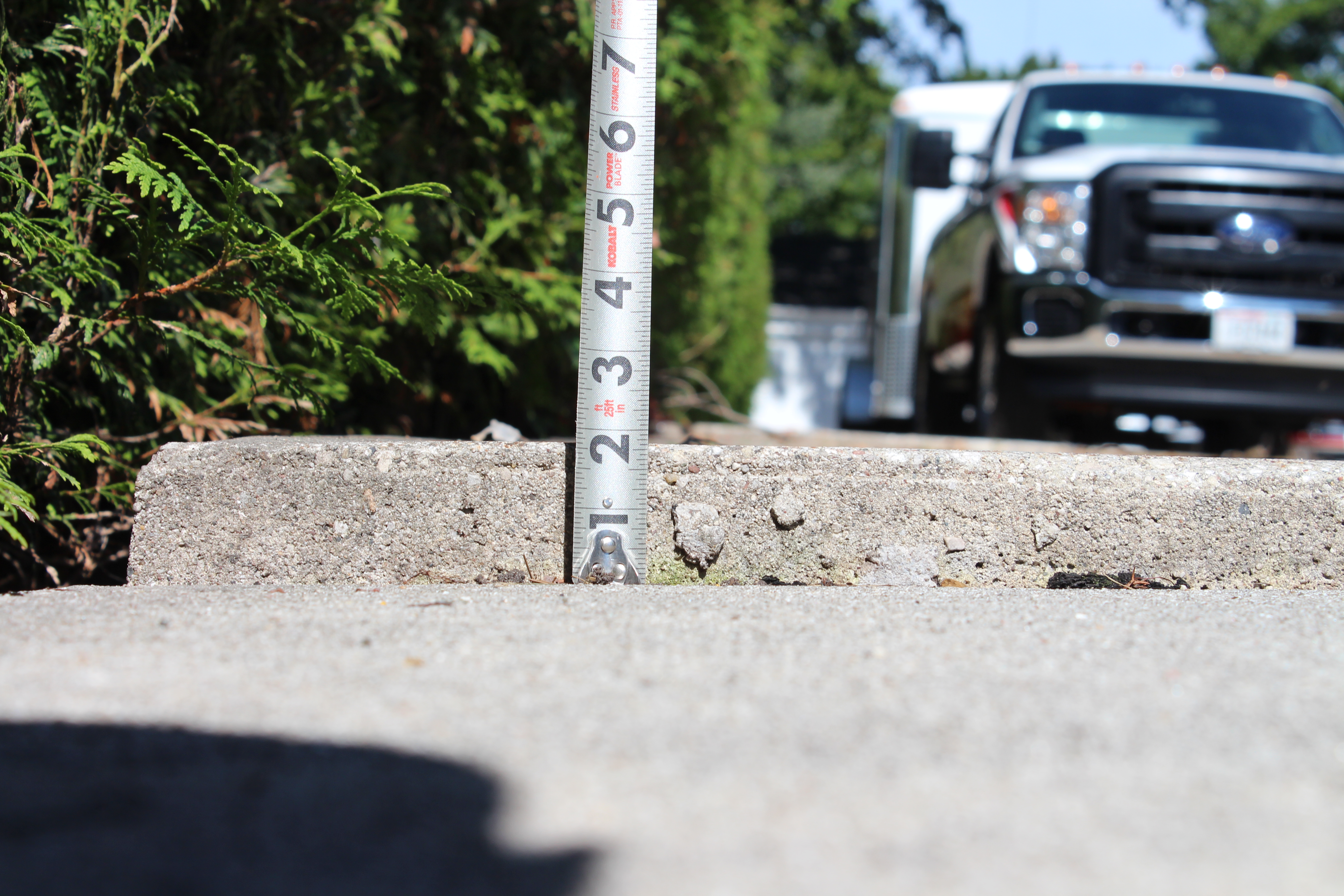 cracked uneven concrete sidewalk trip hazard before leveling Houston TX