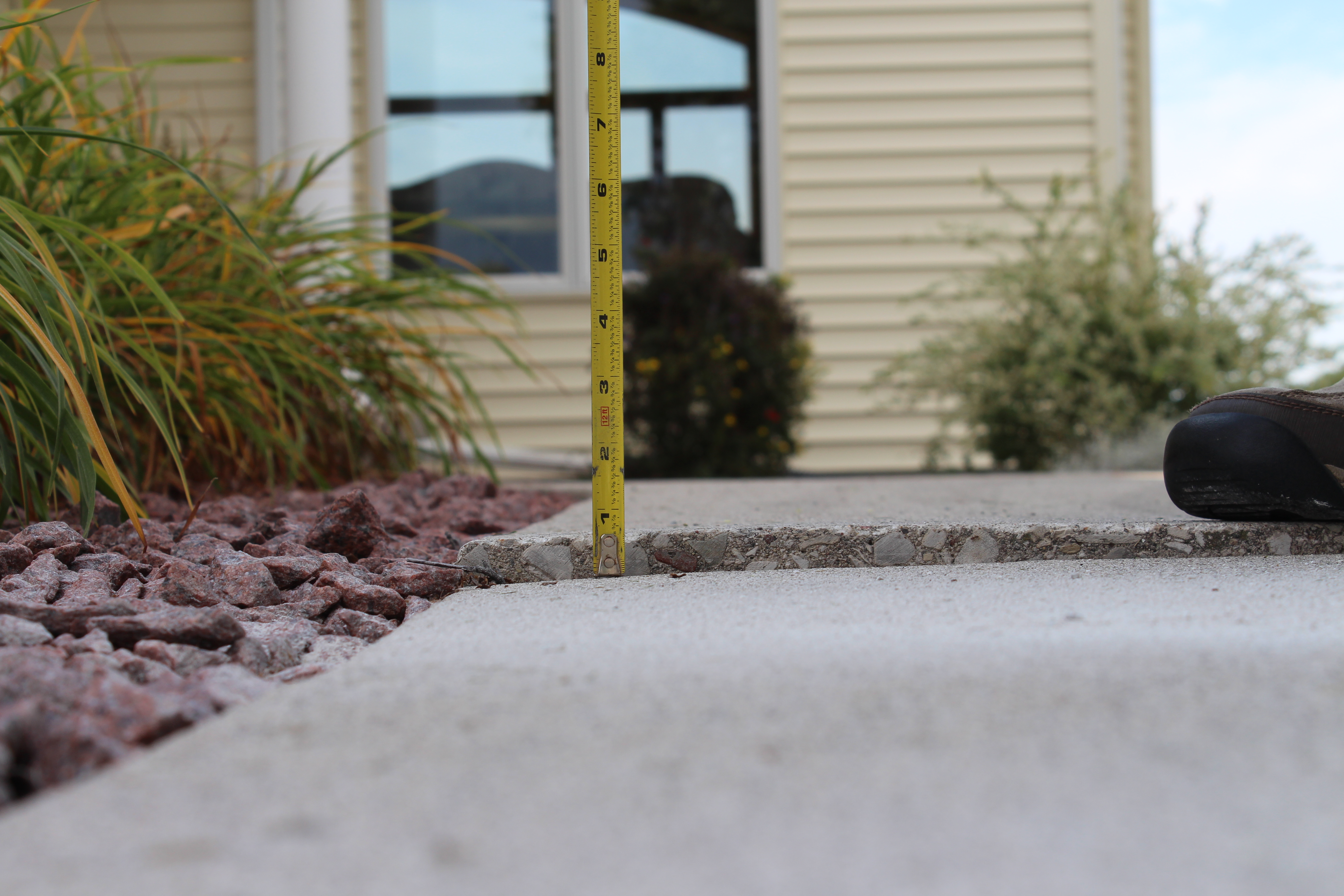 uneven sunken concrete walkway trip hazard before leveling Houston TX